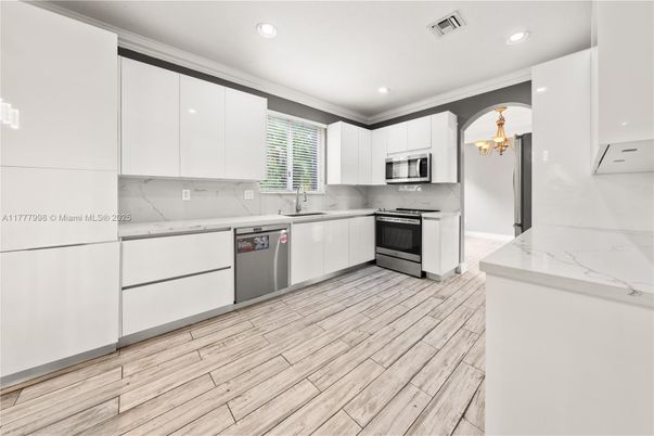 Chandelier, Interior, Kitchen, Marble Walls, Recessed Lighting, Stainless Steel Appliances, Wood Texture Flooring