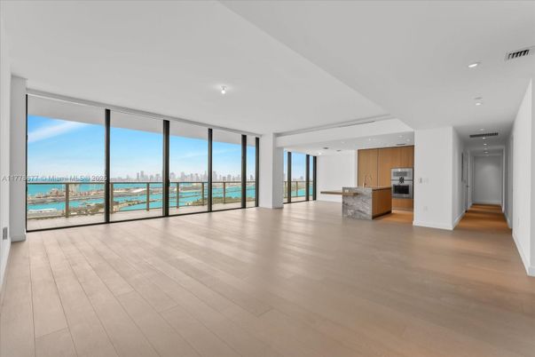 Empty room, Interior, Kitchen, Recessed Lighting, Stainless Steel Appliances, Water, Wood Texture Flooring