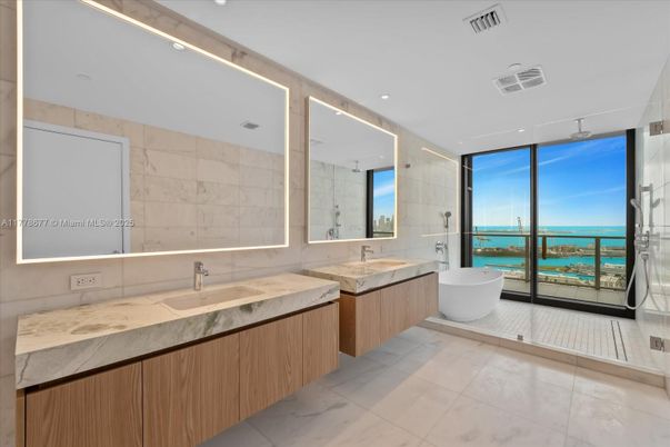Bathroom, Dual Sink Vanities, Free Standing Baths, Glass Shower, Interior, Marble Walls, Recessed Lighting, Water