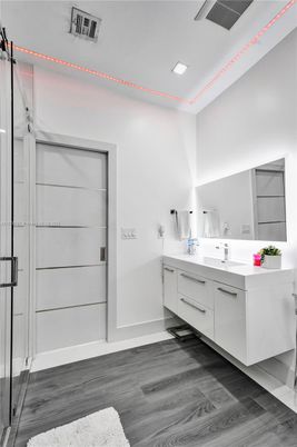 Bathroom, Dual Sink Vanities, Glass Shower, Interior, Recessed Lighting, Wood Texture Flooring