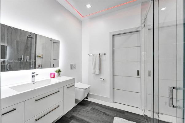 Bathroom, Dual Sink Vanities, Glass Shower, Interior, Recessed Lighting, Wood Texture Flooring
