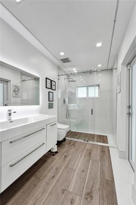 Bathroom, Free Standing Baths, Glass Shower, Interior, Recessed Lighting, Wood Texture Flooring
