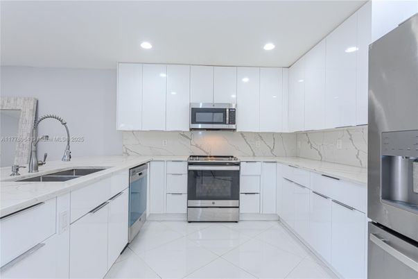 Interior, Kitchen, Marble Walls, Recessed Lighting, Stainless Steel Appliances
