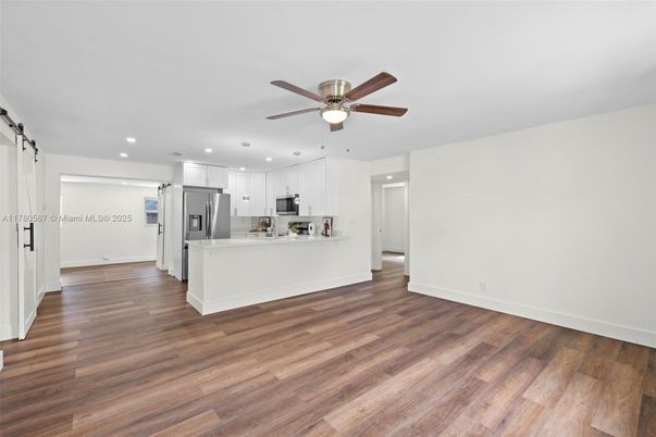 Empty room, Interior, Kitchen, Recessed Lighting, Stainless Steel Appliances, Wood Texture Flooring