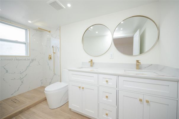 Bathroom, Dual Sink Vanities, Interior, Marble Walls, Recessed Lighting, Wood Texture Flooring