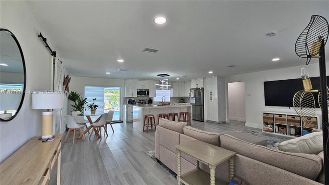 Dining room, Interior, Kitchen, Living room, Pendant Lights, Recessed Lighting, Stainless Steel Appliances, Wood Texture Flooring