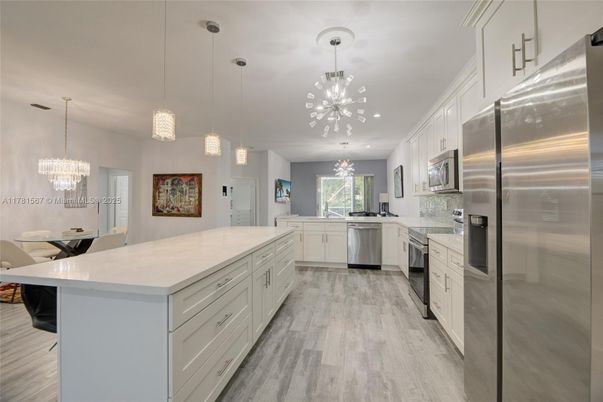 Chandelier, Interior, Kitchen, Pendant Lights, Recessed Lighting, Stainless Steel Appliances, Wood Texture Flooring