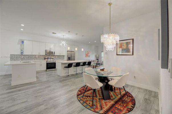 Chandelier, Dining room, Interior, Kitchen, Recessed Lighting, Stainless Steel Appliances, Wood Texture Flooring