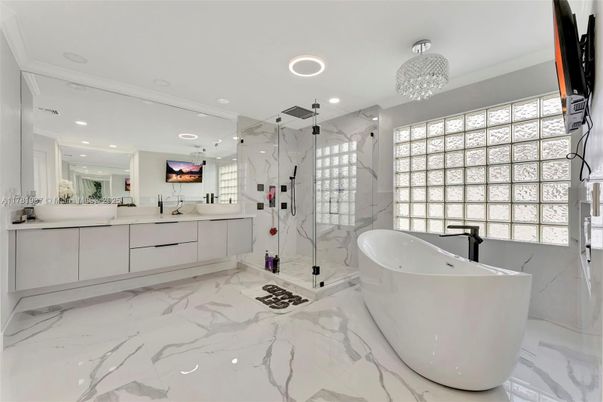 Bathroom, Chandelier, Dual Sink Vanities, Free Standing Baths, Glass Shower, Interior, Marble, Marble Walls, Recessed Lighting