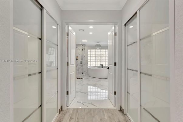 Bathroom, Free Standing Baths, Glass Shower, Interior, Marble, Marble Walls, Recessed Lighting, Wood Texture Flooring