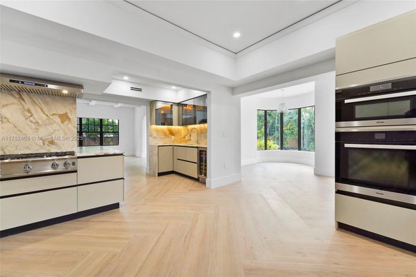 Interior, Kitchen, Marble Walls, Pendant Lights, Recessed Lighting, Stainless Steel Appliances, Wood Texture Flooring