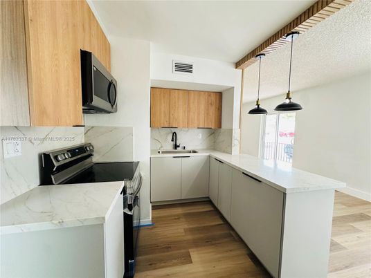 Interior, Kitchen, Marble Walls, Pendant Lights, Stainless Steel Appliances, Wood Texture Flooring