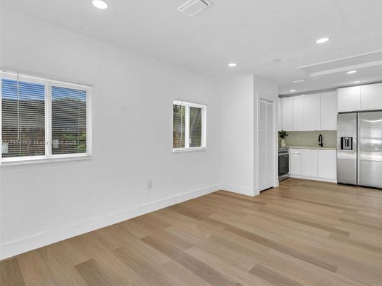 Empty room, Interior, Kitchen, Recessed Lighting, Stainless Steel Appliances, Wood Texture Flooring