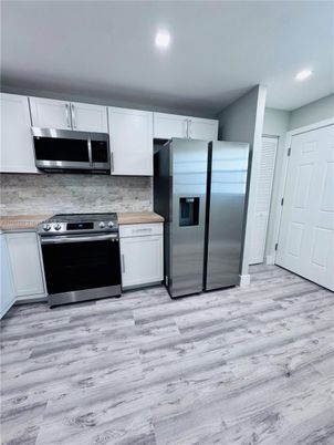 Interior, Kitchen, Recessed Lighting, Stainless Steel Appliances, Wood Texture Flooring