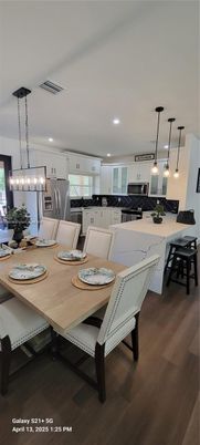 Dining room, Interior, Kitchen, Pendant Lights, Recessed Lighting, Stainless Steel Appliances, Wood Texture Flooring