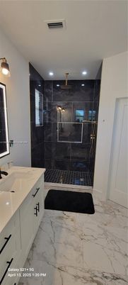 Bathroom, Dual Sink Vanities, Glass Shower, Interior, Marble, Marble Walls, Recessed Lighting