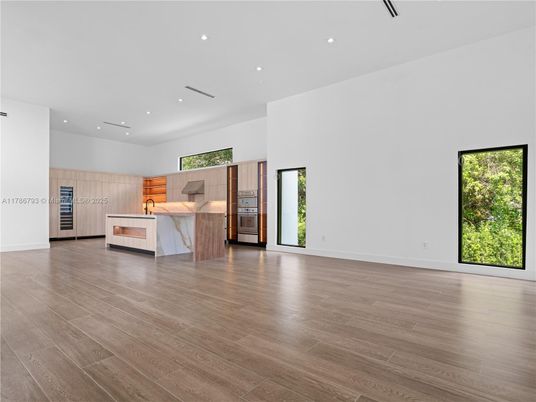 Empty room, Interior, Kitchen, Recessed Lighting, Stainless Steel Appliances, Wood Texture Flooring