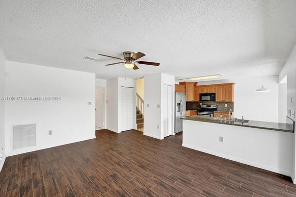 Empty room, Interior, Kitchen, Pendant Lights, Stainless Steel Appliances, Wood Texture Flooring