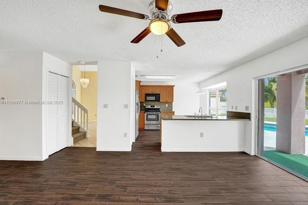 Empty room, Interior, Kitchen, Pendant Lights, Stainless Steel Appliances, Wood Texture Flooring