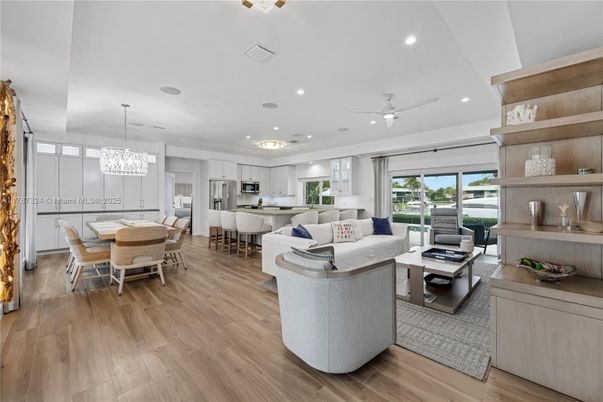 Chandelier, Dining room, Interior, Kitchen, Living room, Pendant Lights, Recessed Lighting, Stainless Steel Appliances, Wood Texture Flooring