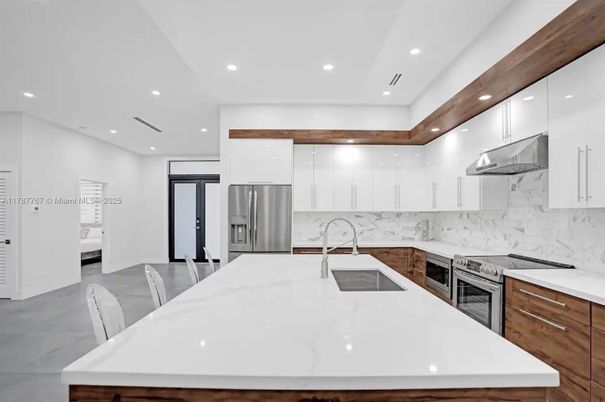 Interior, Kitchen, Marble Walls, Recessed Lighting, Stainless Steel Appliances
