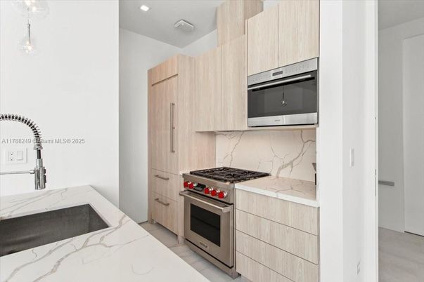 Interior, Kitchen, Marble Walls, Recessed Lighting, Stainless Steel Appliances