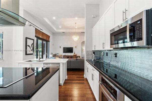 Chandelier, Interior, Kitchen, Living room, Pendant Lights, Recessed Lighting, Stainless Steel Appliances, Wood Texture Flooring