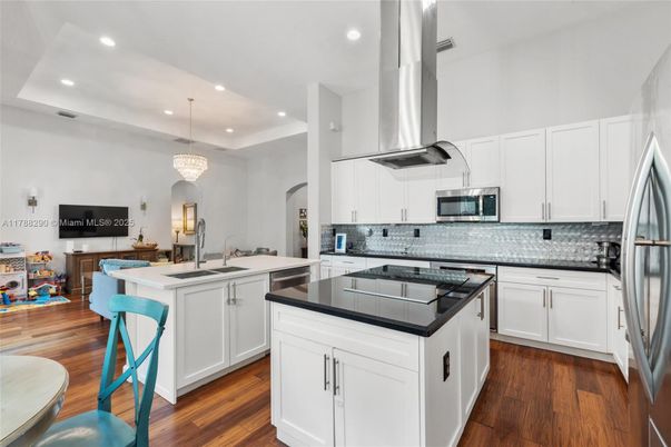 Chandelier, Interior, Kitchen, Pendant Lights, Recessed Lighting, Stainless Steel Appliances, Wood Texture Flooring