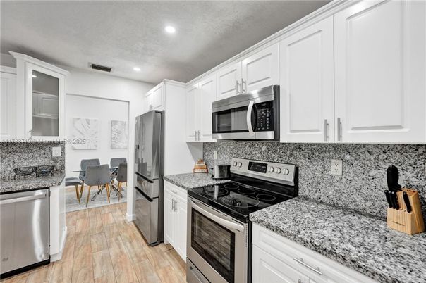 Dining room, Interior, Kitchen, Recessed Lighting, Stainless Steel Appliances, Wood Texture Flooring