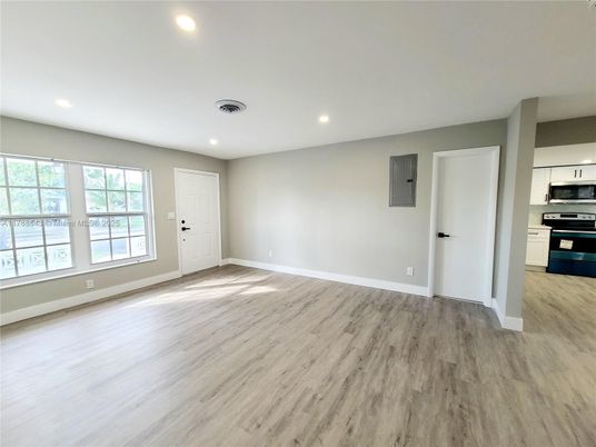 Empty room, Interior, Kitchen, Recessed Lighting, Stainless Steel Appliances, Wood Texture Flooring