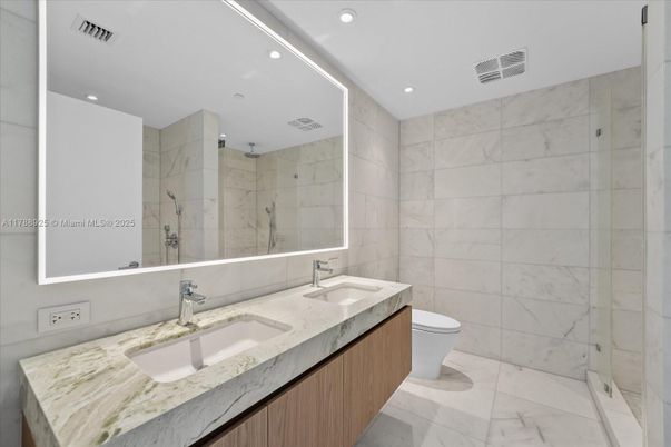 Bathroom, Dual Sink Vanities, Glass Shower, Interior, Marble, Marble Walls, Recessed Lighting