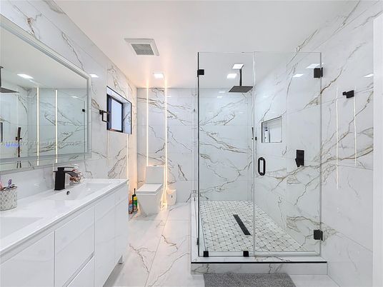 Bathroom, Dual Sink Vanities, Glass Shower, Interior, Marble, Marble Walls, Recessed Lighting
