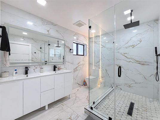 Bathroom, Dual Sink Vanities, Glass Shower, Interior, Marble, Marble Walls, Recessed Lighting