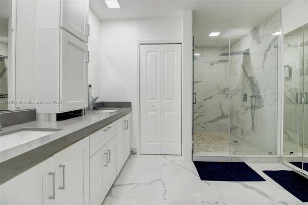 Bathroom, Dual Sink Vanities, Glass Shower, Interior, Marble, Marble Walls, Recessed Lighting