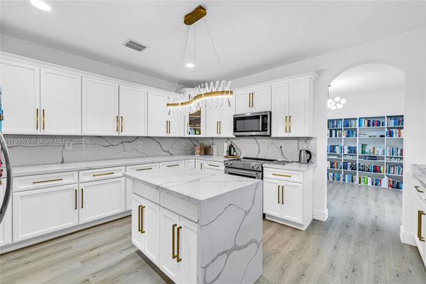 Interior, Kitchen, Marble Walls, Pendant Lights, Recessed Lighting, Stainless Steel Appliances, Wood Texture Flooring