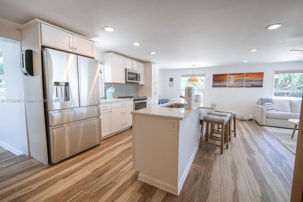 Dining room, Interior, Kitchen, Pendant Lights, Recessed Lighting, Stainless Steel Appliances, Wood Texture Flooring