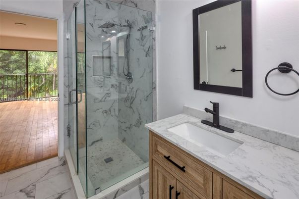 Bathroom, Dual Sink Vanities, Glass Shower, Interior, Marble, Marble Walls, Recessed Lighting, Wood Texture Flooring