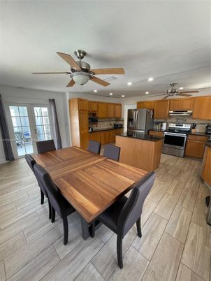 Dining room, Interior, Kitchen, Recessed Lighting, Stainless Steel Appliances, Wood Texture Flooring
