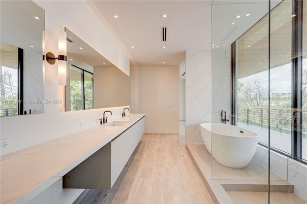 Bathroom, Dual Sink Vanities, Free Standing Baths, Glass Shower, Interior, Marble Walls, Recessed Lighting, Wood Texture Flooring