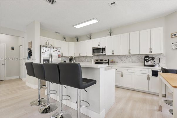 Interior, Kitchen, Marble Walls, Stainless Steel Appliances, Wood Texture Flooring