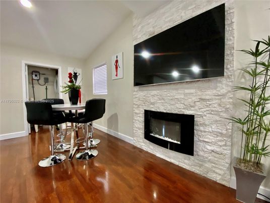 Dining room, Fireplace, Interior, Recessed Lighting, Stone Walls, Wood Texture Flooring