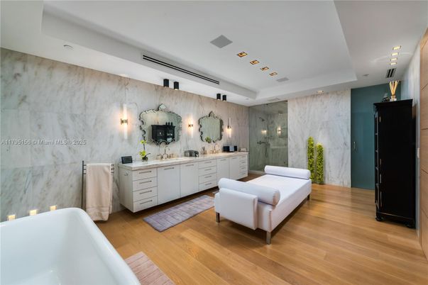 Bathroom, Dual Sink Vanities, Free Standing Baths, Glass Shower, Interior, Marble Walls, Recessed Lighting, Wood Texture Flooring