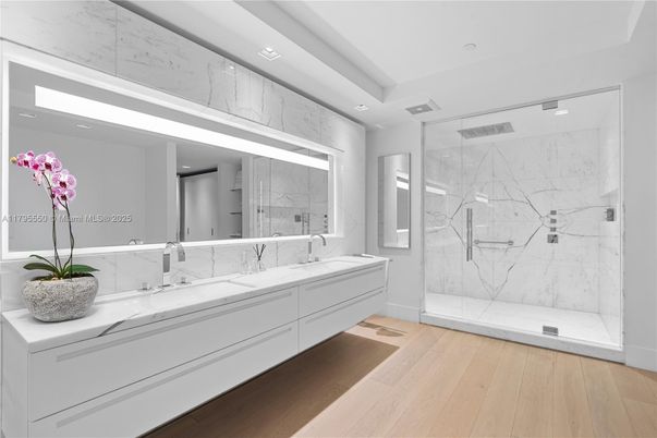 Bathroom, Dual Sink Vanities, Glass Shower, Interior, Marble Walls, Recessed Lighting, Wood Texture Flooring