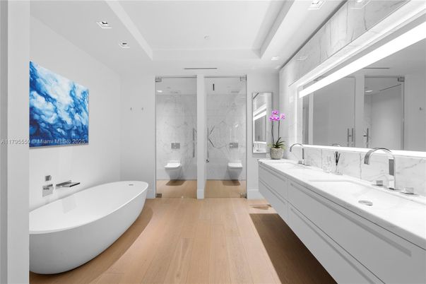 Bathroom, Dual Sink Vanities, Free Standing Baths, Glass Shower, Interior, Marble Walls, Recessed Lighting, Wood Texture Flooring