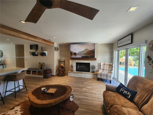 Fireplace, Interior, Living room, Recessed Lighting, Stone Walls, Wood Texture Flooring