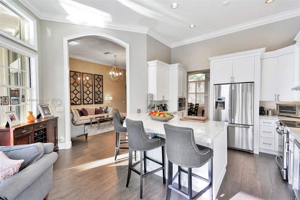Chandelier, Interior, Kitchen, Living room, Recessed Lighting, Stainless Steel Appliances, Wood Texture Flooring