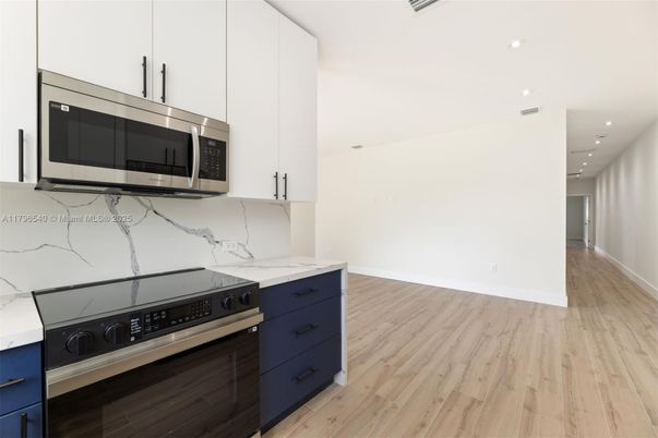 Interior, Kitchen, Marble Walls, Recessed Lighting, Stainless Steel Appliances, Wood Texture Flooring