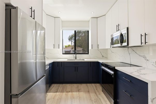 Interior, Kitchen, Marble Walls, Recessed Lighting, Stainless Steel Appliances, Wood Texture Flooring