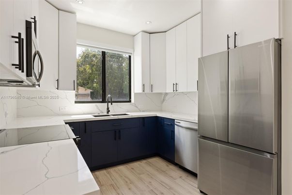 Interior, Kitchen, Marble Walls, Recessed Lighting, Stainless Steel Appliances, Wood Texture Flooring