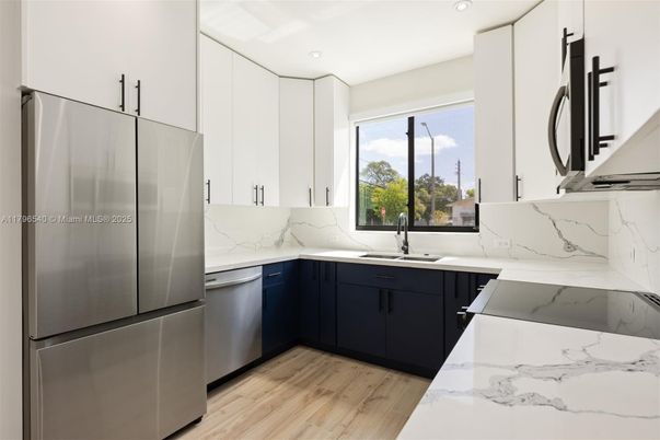 Interior, Kitchen, Marble Walls, Recessed Lighting, Stainless Steel Appliances, Wood Texture Flooring